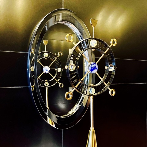 MoonTed Diary: A gold armillary-sphere ornament with a blue globe on a glossy black wall at The Royal Park Hotel Iconic Tokyo Shiodome
