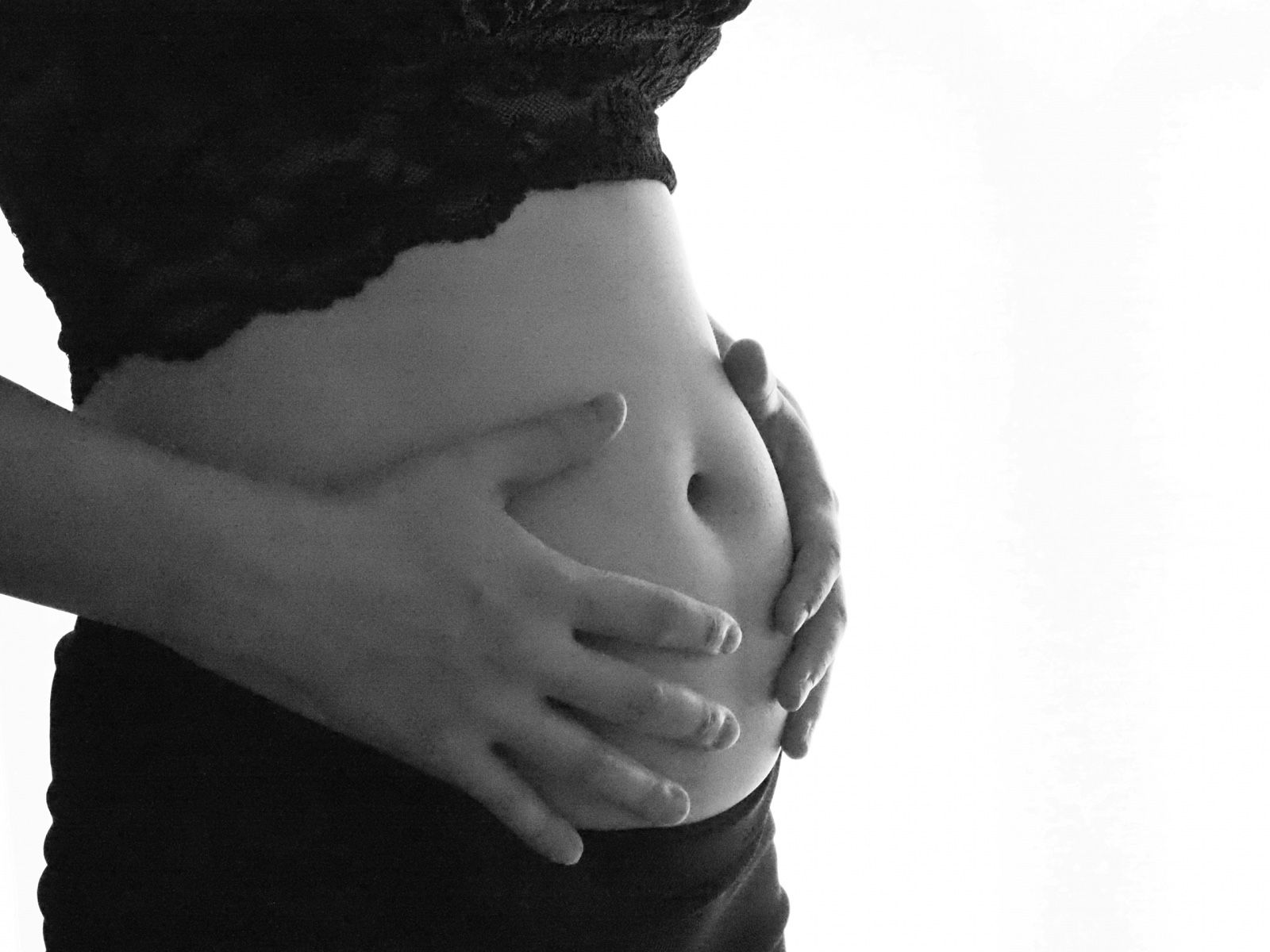 ムーンテッド(MoonTed)の日記より、両手を添えた妊婦さんのお腹。モノクロ写真